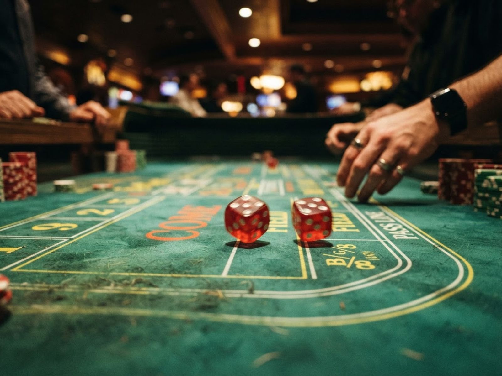 Craps dice rolling on green casino table